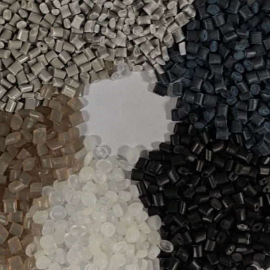 Assorted polymer pellets in gray, black, brown, and white arranged in distinct piles. - Zhejiang Goldcolor Advanced Matetials Co.,Ltd | Cpsemarketplace

