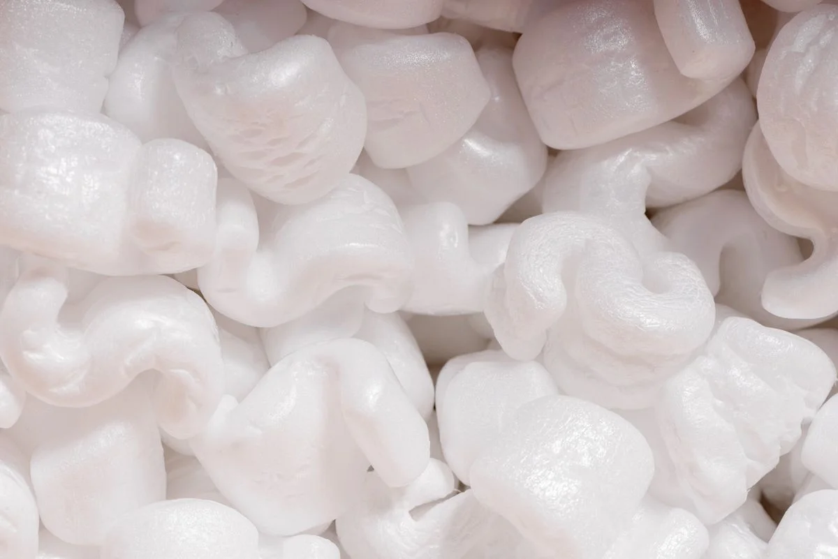 White expanded polystyrene foam packaging peanuts with irregular beaded structure for protective cushioning. - Pexels

